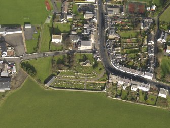 Oblique aerial view centred on the church (s) with the graveyard adjacent, taken from the S.