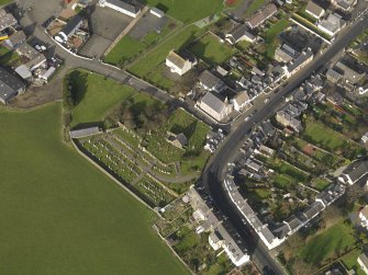 Oblique aerial view centred on the church (s) with the graveyard adjacent, taken from the SE.