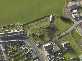 Oblique aerial view centred on the church (s) with the graveyard adjacent, taken from the NE.