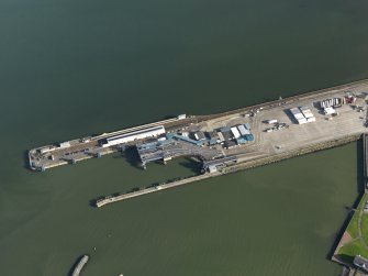 Oblique aerial view centred on the East Pier and railway station, taken from the W.