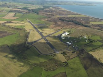 Oblique aerial view centred on the airfield, taken from the W.