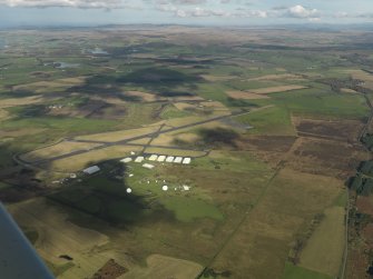 General oblique aerial view centred on the airfield, taken from the S.