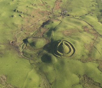 Oblique aerial view centred on the remains of the motte, taken from the WNW.