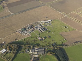 Oblique aerial view centred on the technical site with the control tower adjacent, taken from the S.