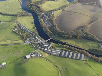 Oblique aerial view centred on the distillery with the village adjacent, taken from the NW.