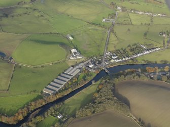 Oblique aerial view centred on the distillery with the village adjacent, taken from the SW.