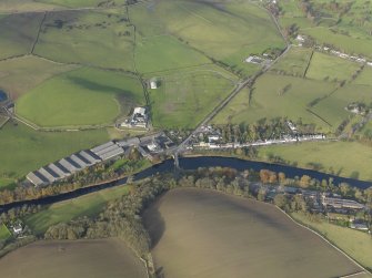 Oblique aerial view centred on the distillery with the village adjacent, taken from the S.
