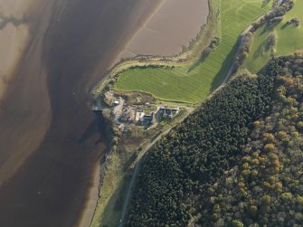 Oblique aerial view centred on the saw mill with the remains of the former Air Sea Rescue yard adjacent, taken from the NNE.