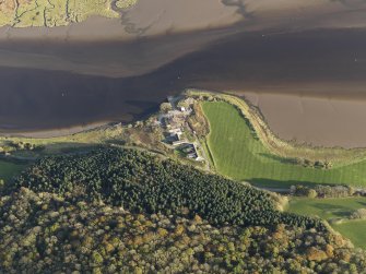 Oblique aerial view centred on the saw mill with the remains of the former Air Sea Rescue yard adjacent, taken from the NW.