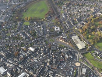 Oblique aerial view centred on the public baths with the town centre adjacent, taken from the ESE.