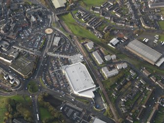 Oblique aerial view centred on the new railway station with a new superstore adjacent, taken from the ESE.
