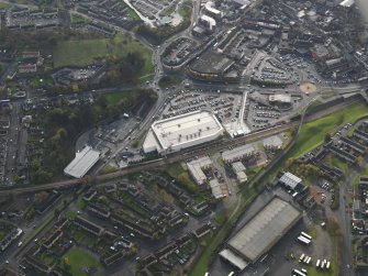 Oblique aerial view centred on the new railway station with a new superstore adjacent, taken from the NE.