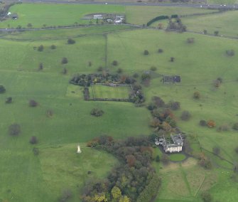 Oblique aerial view centred on the country house with the walled garden adjacent, taken from the N.