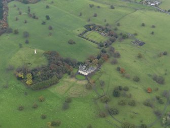Oblique aerial view centred on the country house with the walled garden adjacent, taken from the NW.