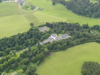 General oblique aerial view centred on the hotel with the stables adjacent, taken from the NE.