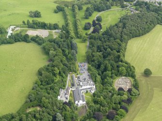 General oblique aerial view centred on the hotel with the stables adjacent, taken from the WSW.
