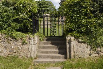 W entrance to National Trust site, with view of steps and gatepiers from W. The gatepiers are made out of reused dressed stones from the abbey with double roll mouldings that may have decorated piers in the church.