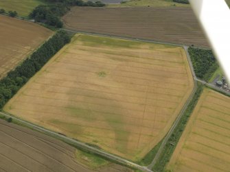Oblique aerial view centred on the linear cropmarks and the cropmarks of the rig and furrow at Burleigh, taken from the NW.
