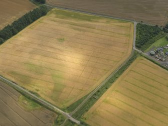 Oblique aerial view centred on the linear cropmarks and the cropmarks of the rig and furrow at Burleigh, taken from the NW.