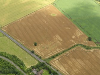 Oblique aerial view centred on the cropmarks of the drains at Huttonburn Bridge, taken from the W.