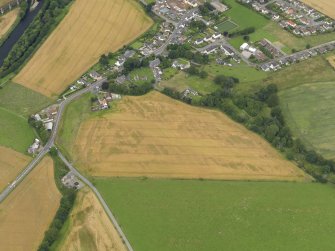 Oblique aerial view of the cropmarks of the rig and furrow, unenclosed settlement and pits at Marykirk, taken from the SE.