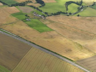 General oblique aerial view of the cropmarks of the rig and furrow and Drumtogle Mill, taken from the E.