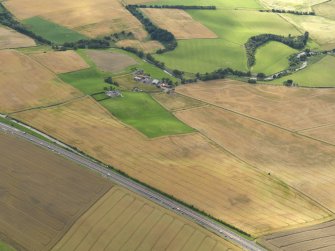 General oblique aerial view of the cropmarks of the rig and furrow and Drumtogle Mill, taken from the E.