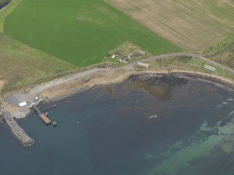 Oblique aerial view centred on the ferry terminal with the farmstead adjacent, taken from the S.