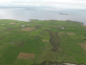 General oblique aerial view centred on the Blows Moss area of South Ronaldsay looking to Caithness, taken from the ENE.