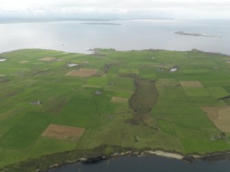 General oblique aerial view centred on the Blows Moss area of South Ronaldsay looking to Caithness, taken from the ENE.