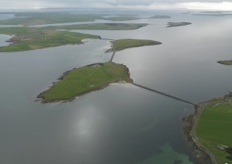 General oblique aerial view centred on Lamb Holm airfield with the causeways adjacent, taken from the NE.