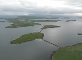 General oblique aerial view centred on Lamb Holm airfield with the causeways adjacent, taken from the  NNE.