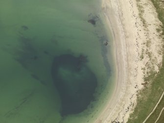 Oblique aerial view centred on the wrecks and blockships to the ESE of Churchill Barrier No 4, taken from the NNE.