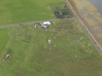 Oblique aerial view centred on the Garrison Theatre with the farmstead adjacent, taken from the W.
