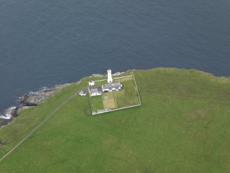 Oblique aerial view centred on the lighthouse with the keepers' cottage adjacent, taken from the NW.