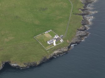 Oblique aerial view centred on the lighthouse with the keepers' cottage adjacent, taken from the S.