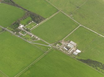 Oblique aerial view centred on the Country House with the Home Farm adjacent, taken from the W.