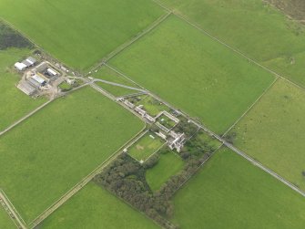 Oblique aerial view centred on the Country House with the Home Farm adjacent, taken from the E.