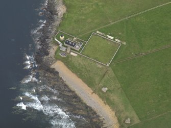 Oblique aerial view centred on the lighthouse with the coastal gun battery adjacent, taken from the WNW.