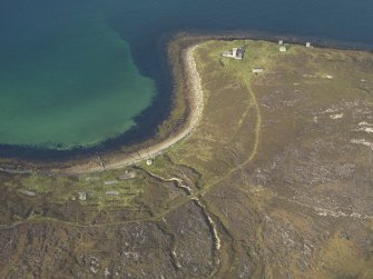 General oblique aerial view centred on the accommodation camp with the coastal gun battery adjacent, taken from the W.