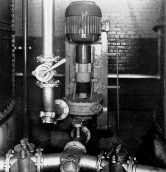 Copy of photograph of paper making machine (no.6), vertical type stock pump which draws fom the bottom of the chests and discharges into a constant level headbox ensuring a a steady flow through the plant to the machine. A HOPKINSON consistency Regulator takes care of any stock density variations, from the JB&S Machine 161 catalogue, James Bertram and Son Ltd, Leith Walk, Edinburgh, circa 1953. The catalogue describes and illustrates some of the features of the No 161 machine 'recently installed at the well known Mill of Guard Bridge Paper Co Ltd, Fife , Scotland designed with the co-operation of the Mill Staff especially for the economical production of the highest quality papers...'