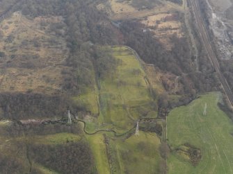 Oblique aerial view centred on the remains of the Roman Fort, taken from the WSW.