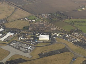 Oblique aerial view centred on the WW II aircraft hangar, taken from the SSE.