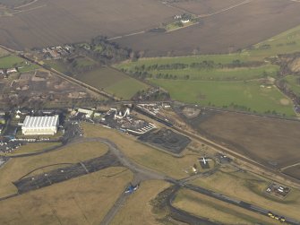 Oblique aerial view centred on the WW II aircraft hangar, taken from the SE.