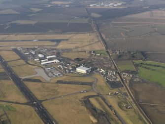 General oblique aerial view centred on the air freight centre with the WW II aircraft hangar adjacent, taken from the ESE.