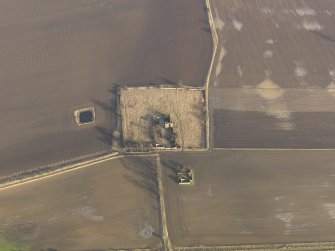 Oblique aerial view centred on the remains of the castle with the remains of the farmstead adjacent, taken from the W.