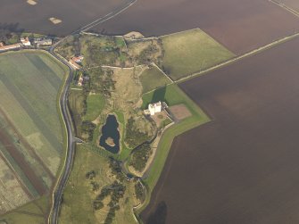 General oblique aerial view centred on the tower house, taken from the SSW.