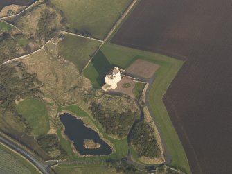 Oblique aerial view centred on the tower house, taken from the SW.