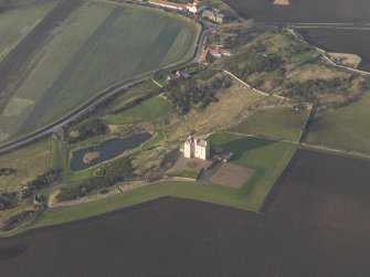 Oblique aerial view centred on the tower house, taken from the SE.