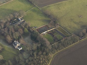Oblique aerial view centred on the farmhouse with the walled garden and coach house adjacent, taken from the NW.